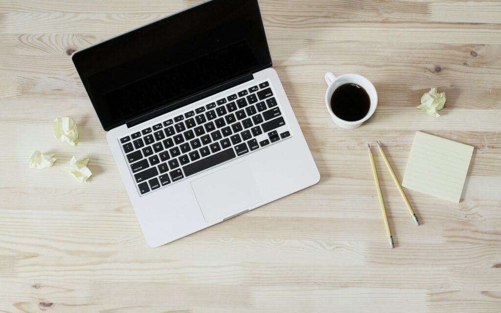 Laptop and coffee on a desk, ready to talk about a new website