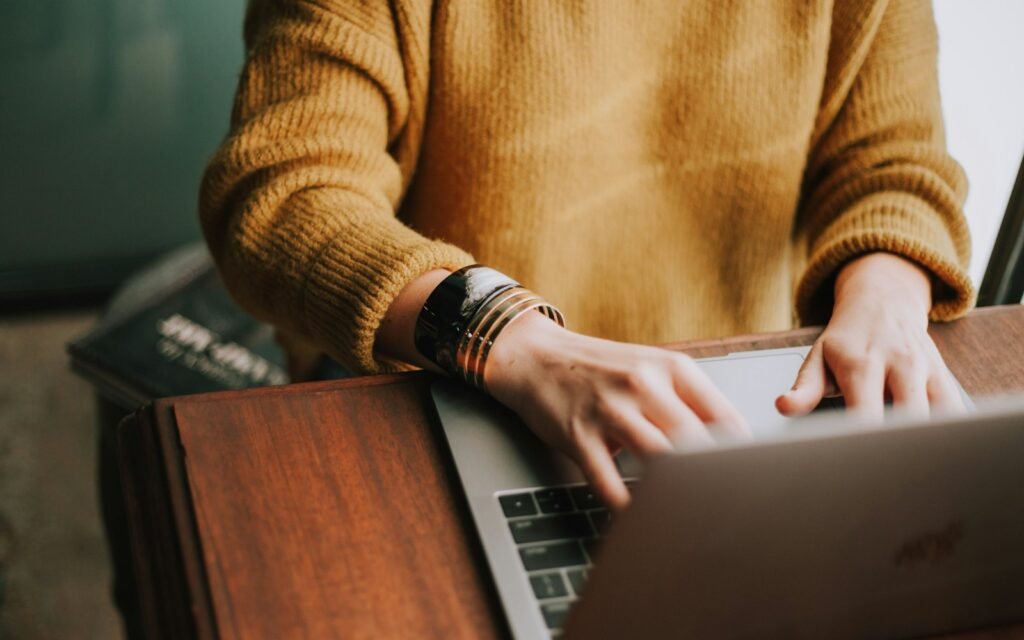 Hands typing on a laptop while updating a website