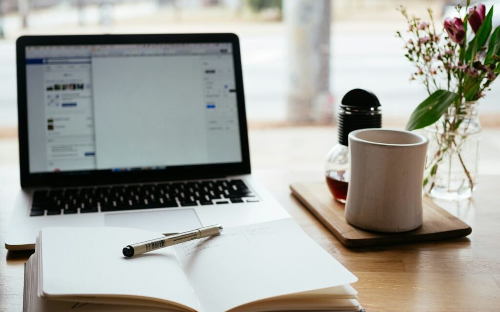 Laptop, mug and pen ready for writing website copy